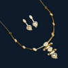 Gold necklace and earrings on a red background with decorative leaves.