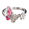 Silver ring with pink butterfly and flower design on a white background