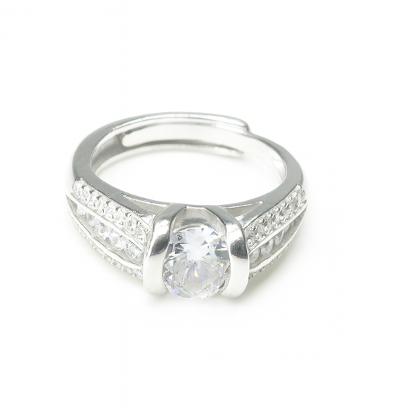 Silver ring with a large central gemstone and smaller stones on the band against a white background