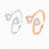 Two heart-shaped rings, one silver and one rose gold, on a white background.