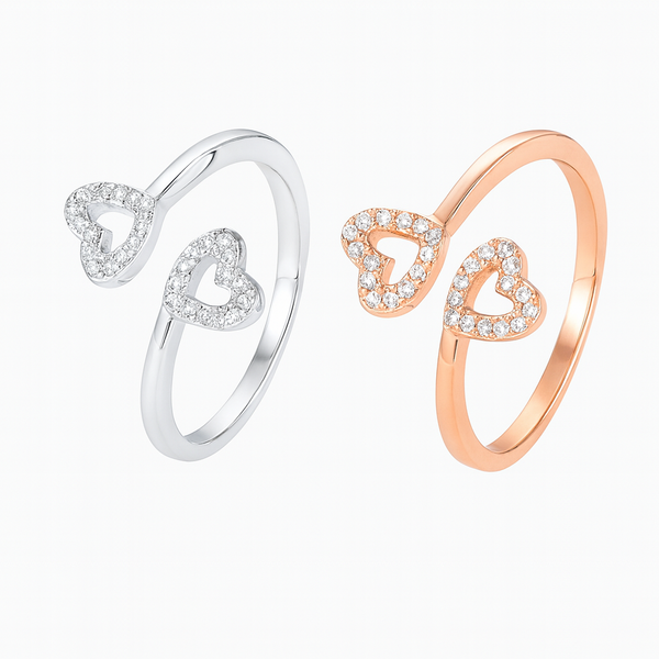 Two heart-shaped rings, one silver and one rose gold, on a white background.