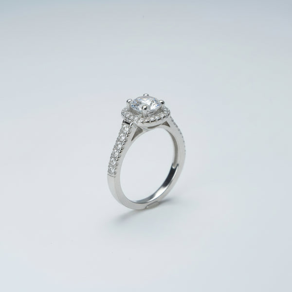 Silver ring with a diamond on a gray background