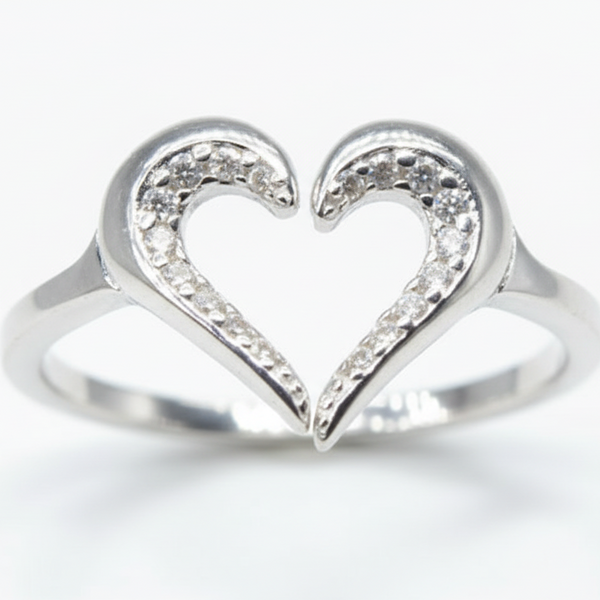 Heart-shaped silver ring with small diamonds on a white background