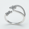 Silver butterfly-shaped ring on a light gray background