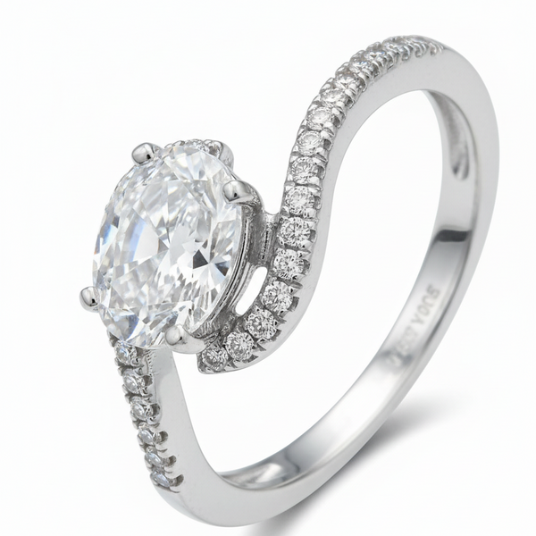 Silver ring with a large central diamond and smaller diamonds on the band against a white background