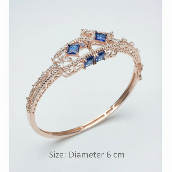 Rose gold ring with blue gemstones on a light gray background