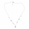 Silver necklace with heart-shaped pendants on a wooden surface