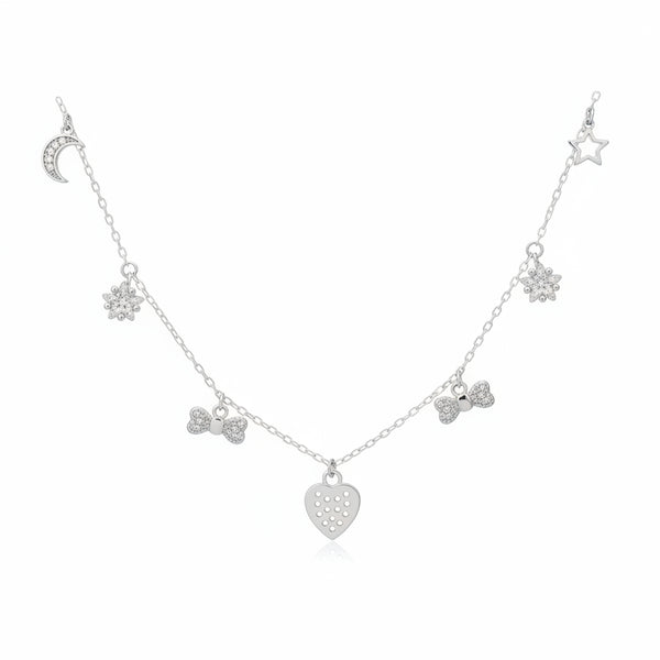 Silver necklace with heart and bow-shaped charms on a dark background