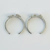 Pair of silver crescent moon earrings on a light gray background