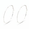 Two silver anklets on a white background