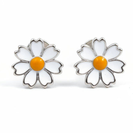 Daisy-shaped earrings with white petals and a yellow center on a white background