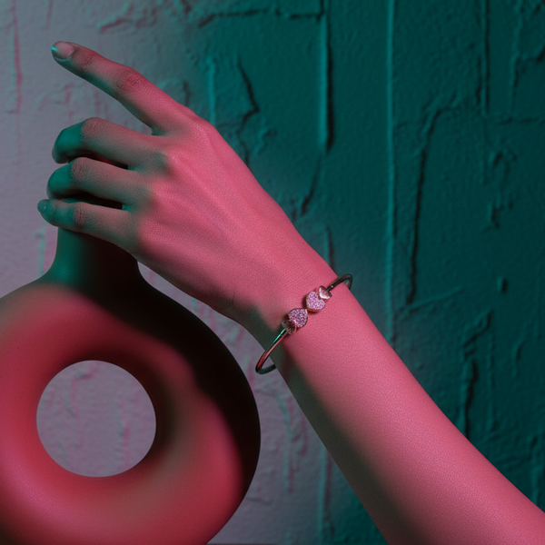 Hand holding a red object against a textured teal wall