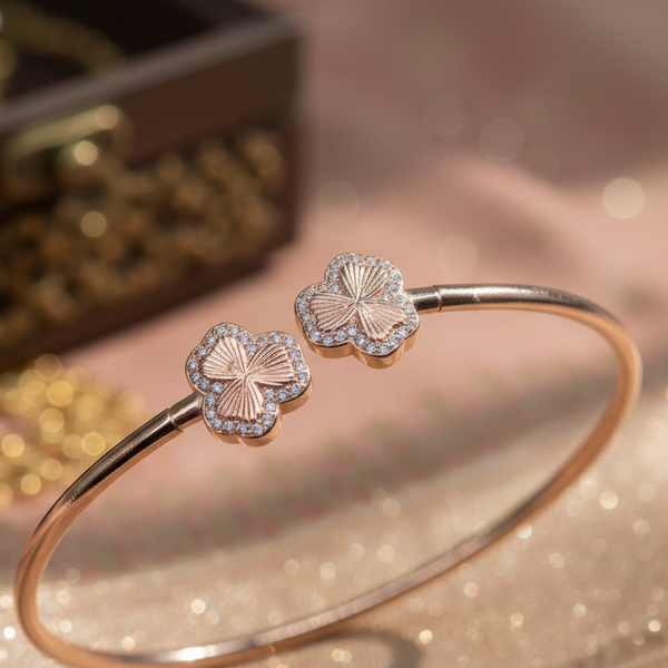 Gold bracelet with floral designs on a glittery surface