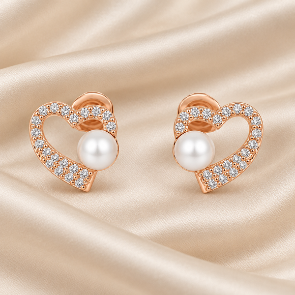 Heart-and-pearl earrings on champagne silk