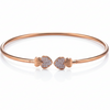 Rose gold bracelet with heart-shaped ends on a white background