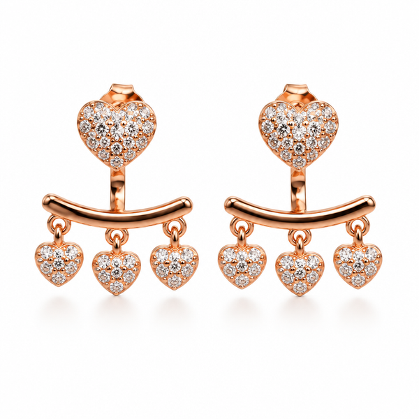 Rose-gold heart earrings on white