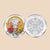 Silver coin with colorful design on one side and intricate pattern on the other, on a dark purple background.