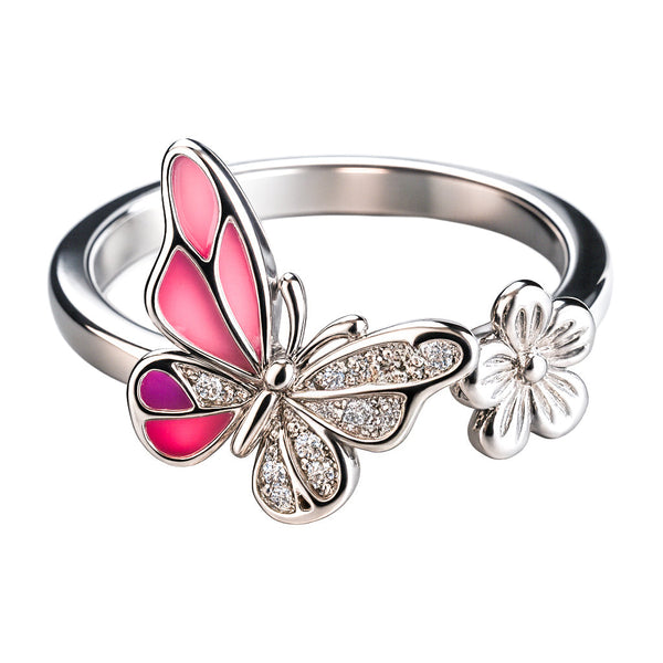 Silver ring with pink butterfly and flower design on a white background