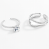 Two silver rings with gemstones on a white background