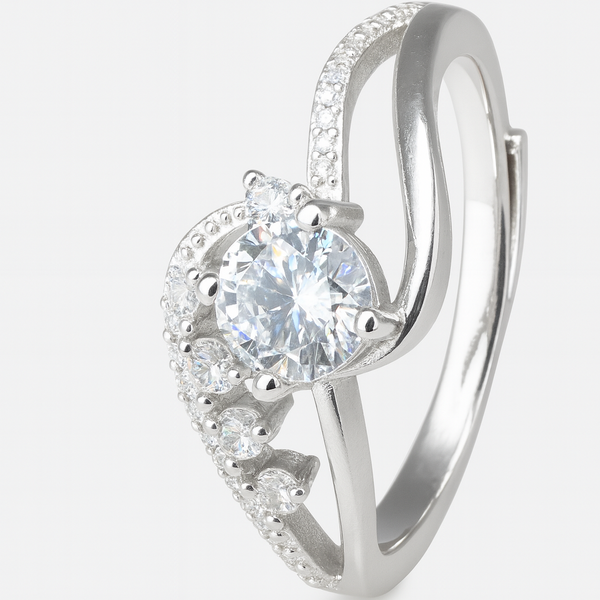 Silver heart-shaped earring with a central gemstone on a white background