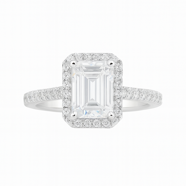 Diamond ring with emerald-cut center stone on a white background