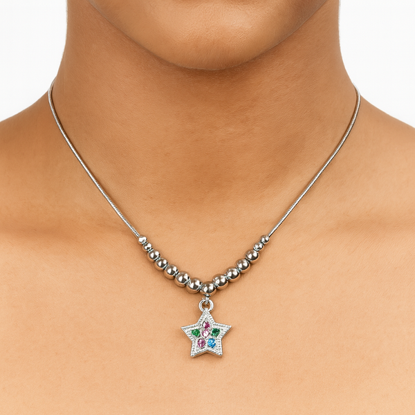 Necklace with a star-shaped pendant featuring colorful stones on a person's neck.