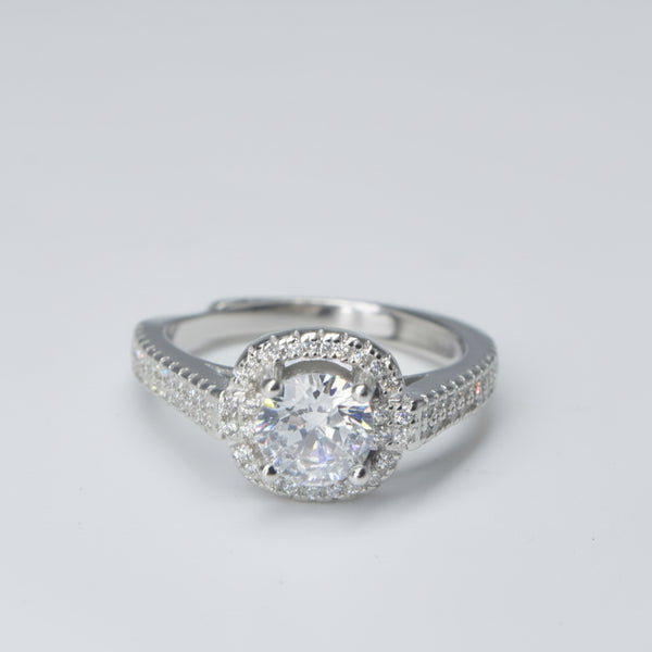 Silver ring with a diamond on a gray background