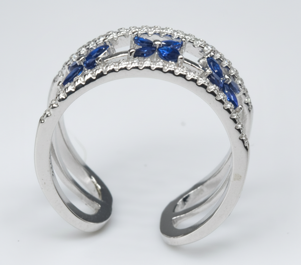 Silver ring with blue gemstones on a white background