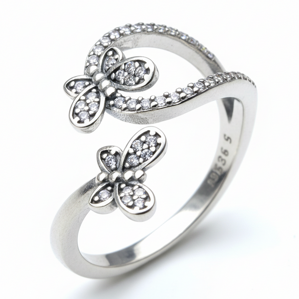 Silver butterfly-shaped ring on a light gray background