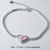 Silver bracelet with a pink heart charm on a light gray background