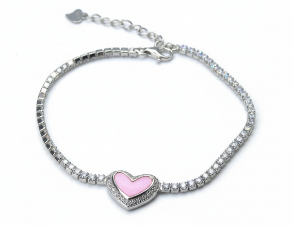 Silver bracelet with a pink heart charm on a light gray background