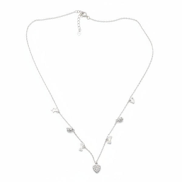 Silver necklace with heart-shaped pendants on a wooden surface