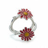 Silver ring with red flower-shaped charms on a white background