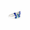 Butterfly-shaped ring with blue and green design on a white background