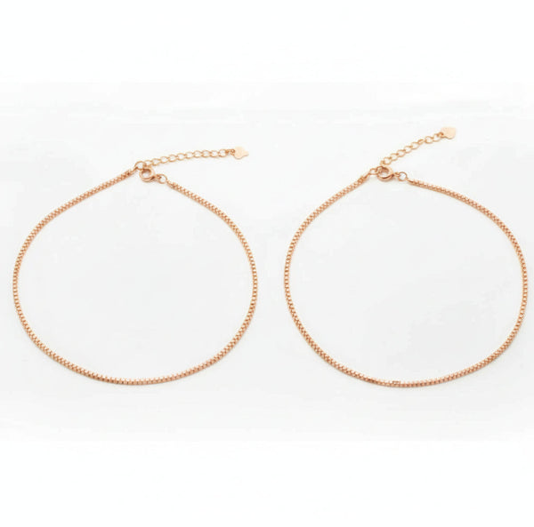 Two gold necklaces on a white background