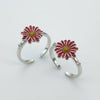 Two silver hoop earrings with red flower designs on a white background