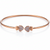 Rose gold bracelet with heart-shaped ends on a white background