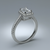 Silver ring with a diamond on a gray background
