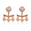 Rose-gold heart earrings on white
