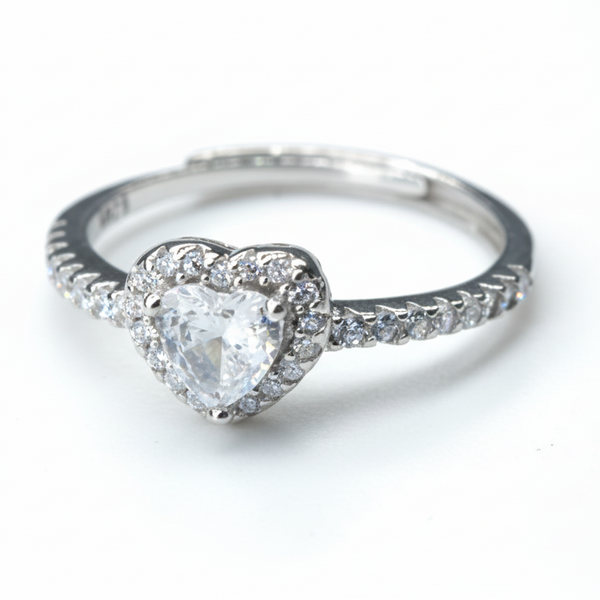 Silver ring with a heart-shaped diamond on a white background